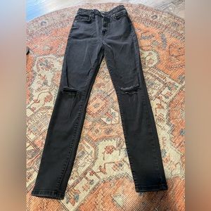 Black skinny jeans with rips in the knees